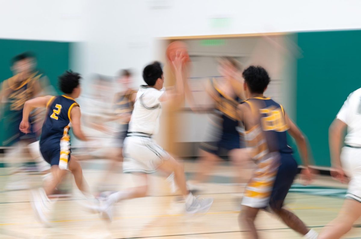 Guard Daniel Zhu (11) hurtles through traffic for a layup. Despite only playing 9 minutes, Daniel brought a spark off the bench: he lodged a fourth-highest plus-minus of -3 and contributed 7 points, an assist, and a steal.