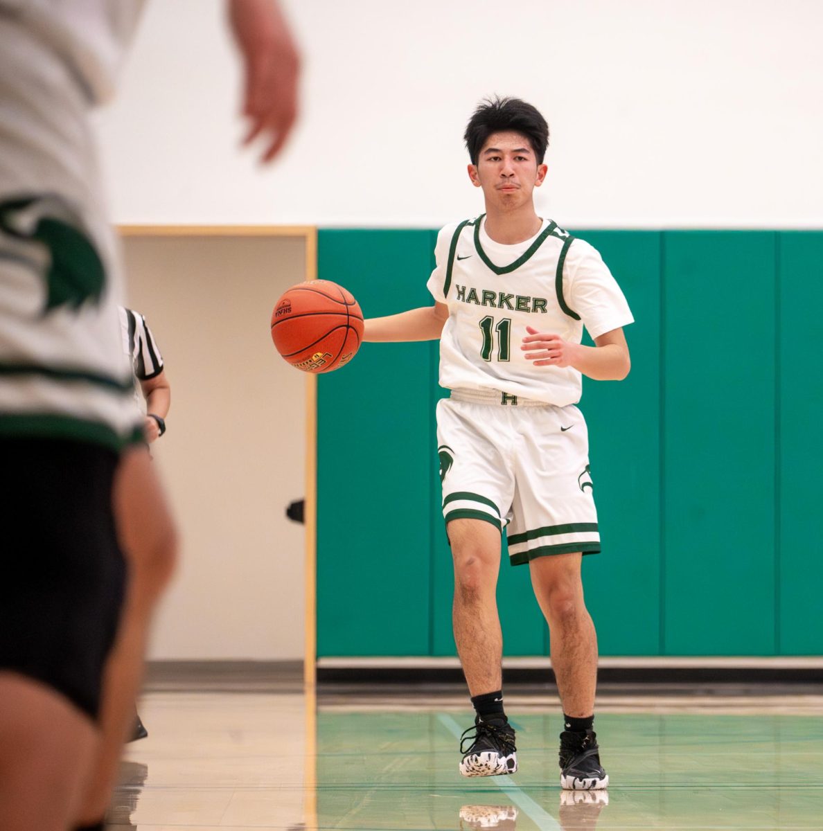 Guard Ethan Xu (9) dribbles down the court at the start of the first quarter. Harker took an early 8-2 lead.