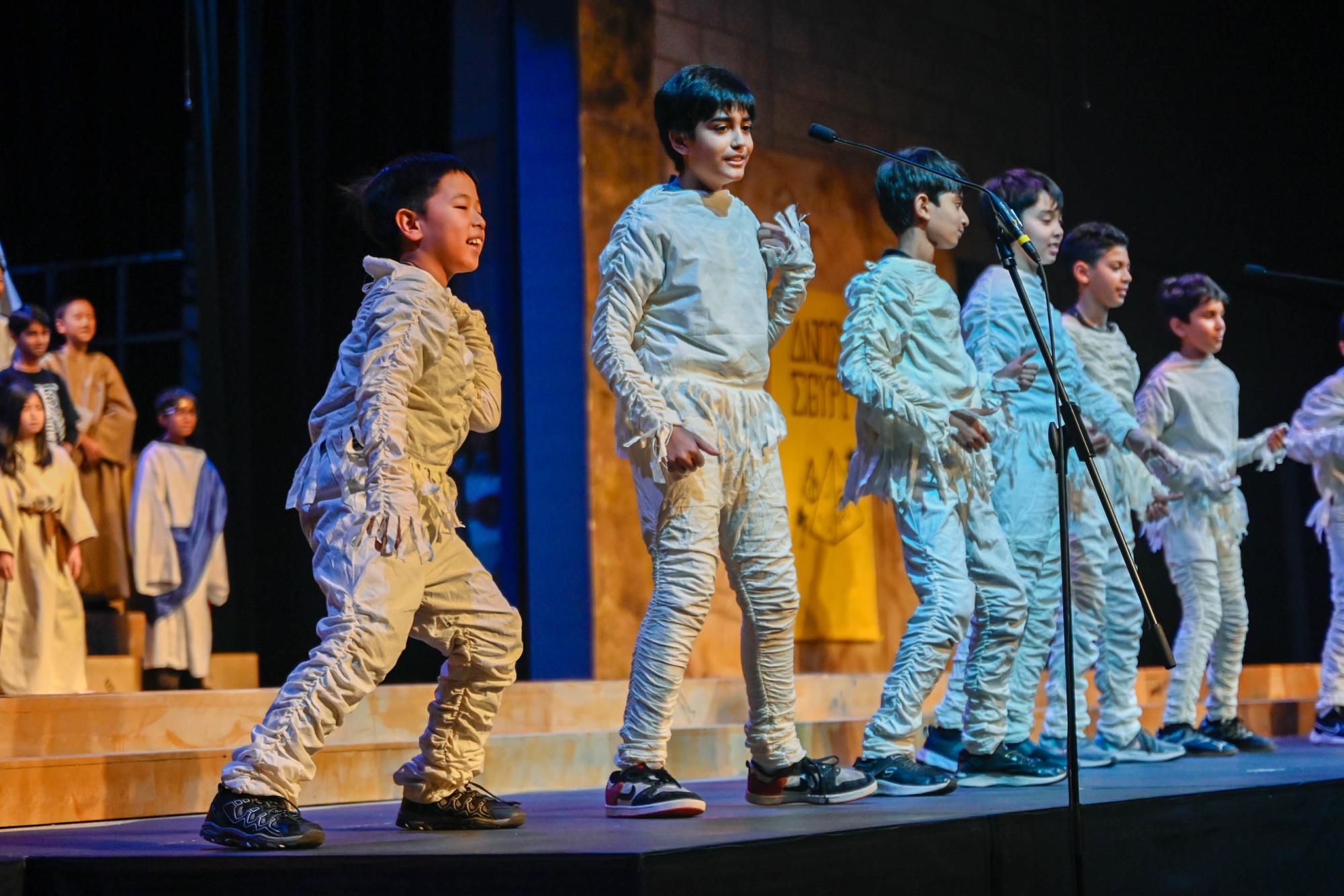 Fifth graders dressed as mummies perform in their show "Dig It!". The play transported the audience through ancient civilizations, including Mesopotamia, Greece and China.