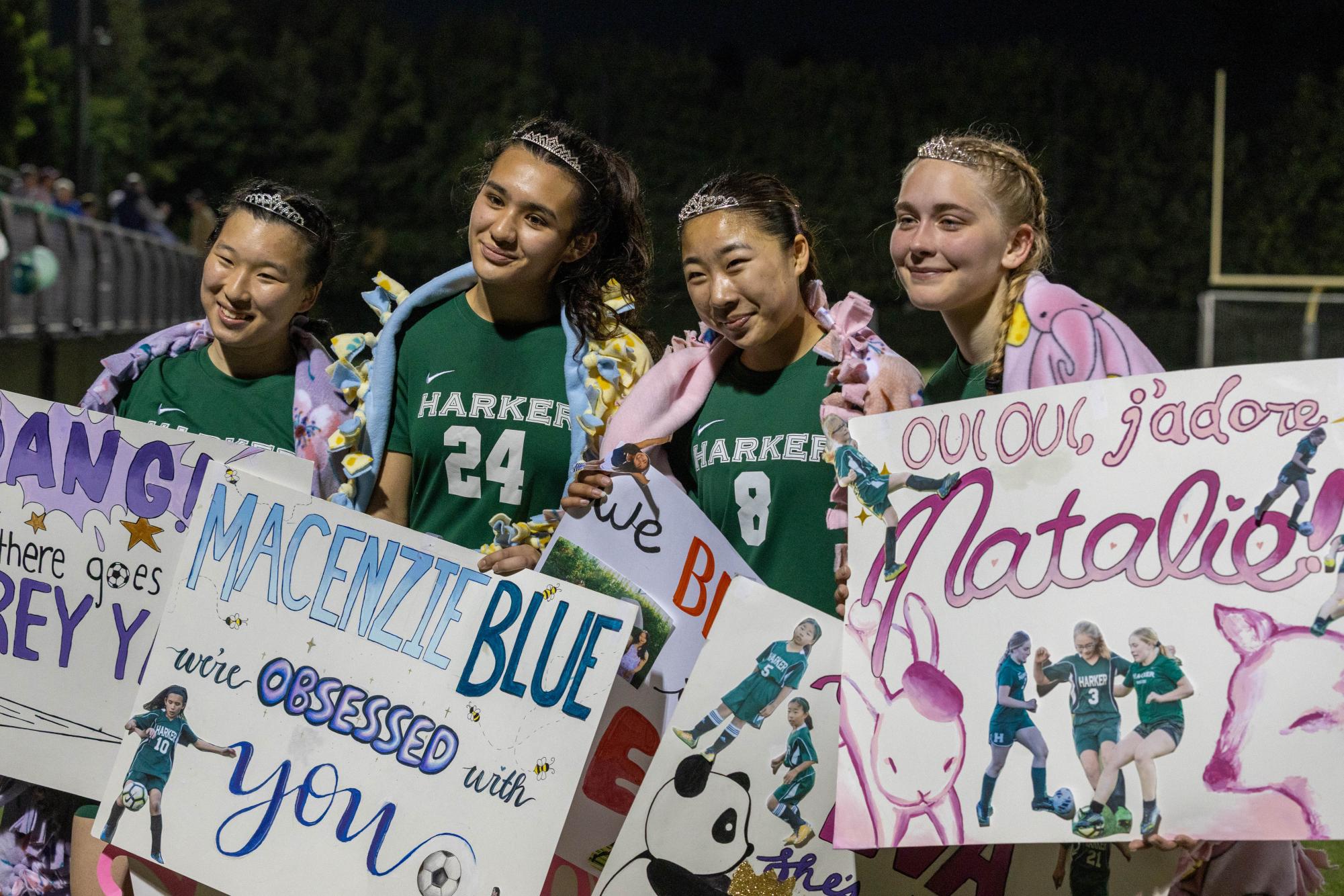 Seniors Audrey Yang, MacEnzie Blue, Eva Cheng and Natalie Barth smile for a picture. Teammates gifted tiaras, blankets and personalized posters to each senior after the game.