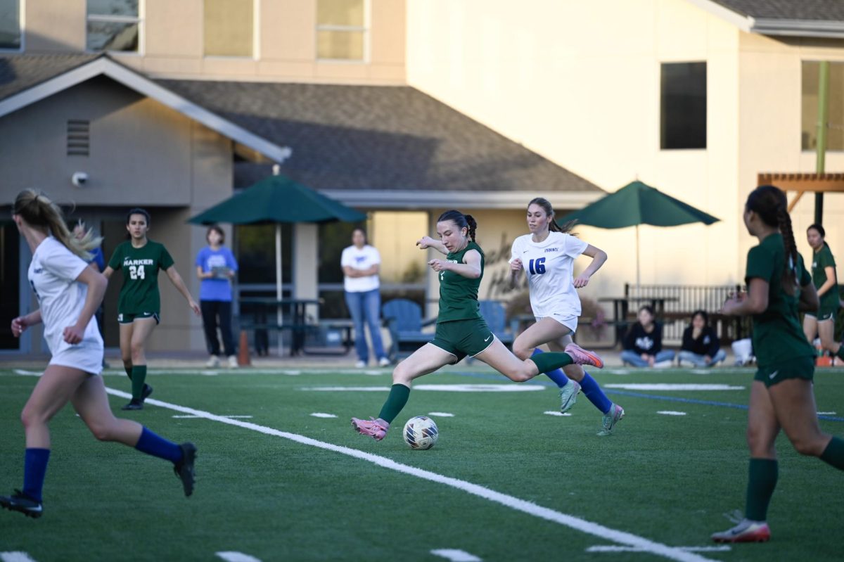Midfielder Kaitlyn Nelson (11) extends her leg to shoot. She controlled the midfield throughout this game, taking multiple corner kicks.