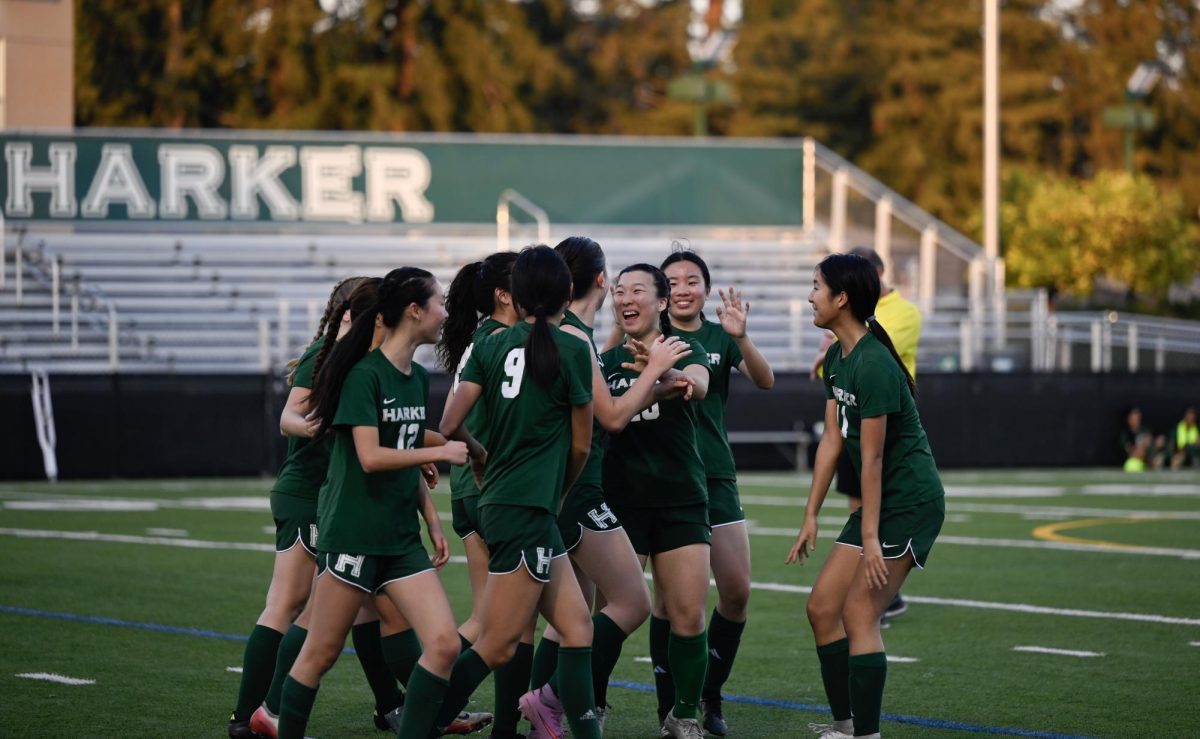 Varsity girls soccer team celebrates after another goal. The senior game ended with a final score of 11-0.