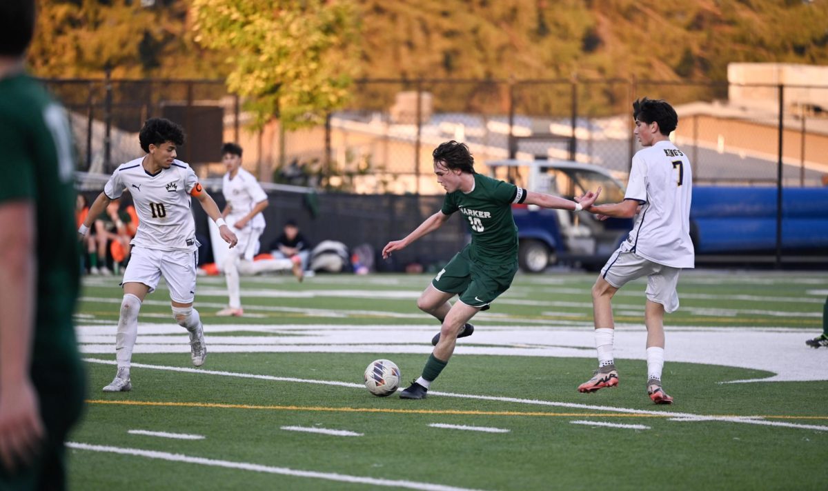 Varsity boys soccer midfielder Ryder Hewitt (12) controls the ball at the midfield during their senior night game against King's Academy. Ryder directed multiple passes towards the forwards during this tight 0-0 game.