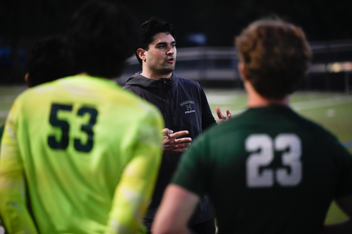 Head coach Seena Sajadieh debriefs with the team. during halftime. He told the boys to continue going for the ball even if they fail the first time.