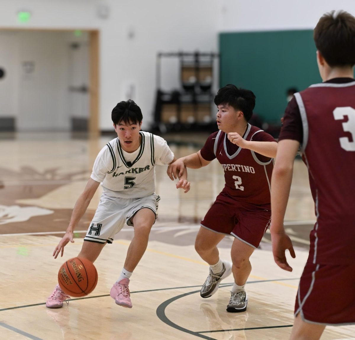 Varsity boys basketball guard Stephen Gao (9) drives the ball, looking for an opening. Even as a frosh, Stephen led the team with multiple threes and offensive plays.