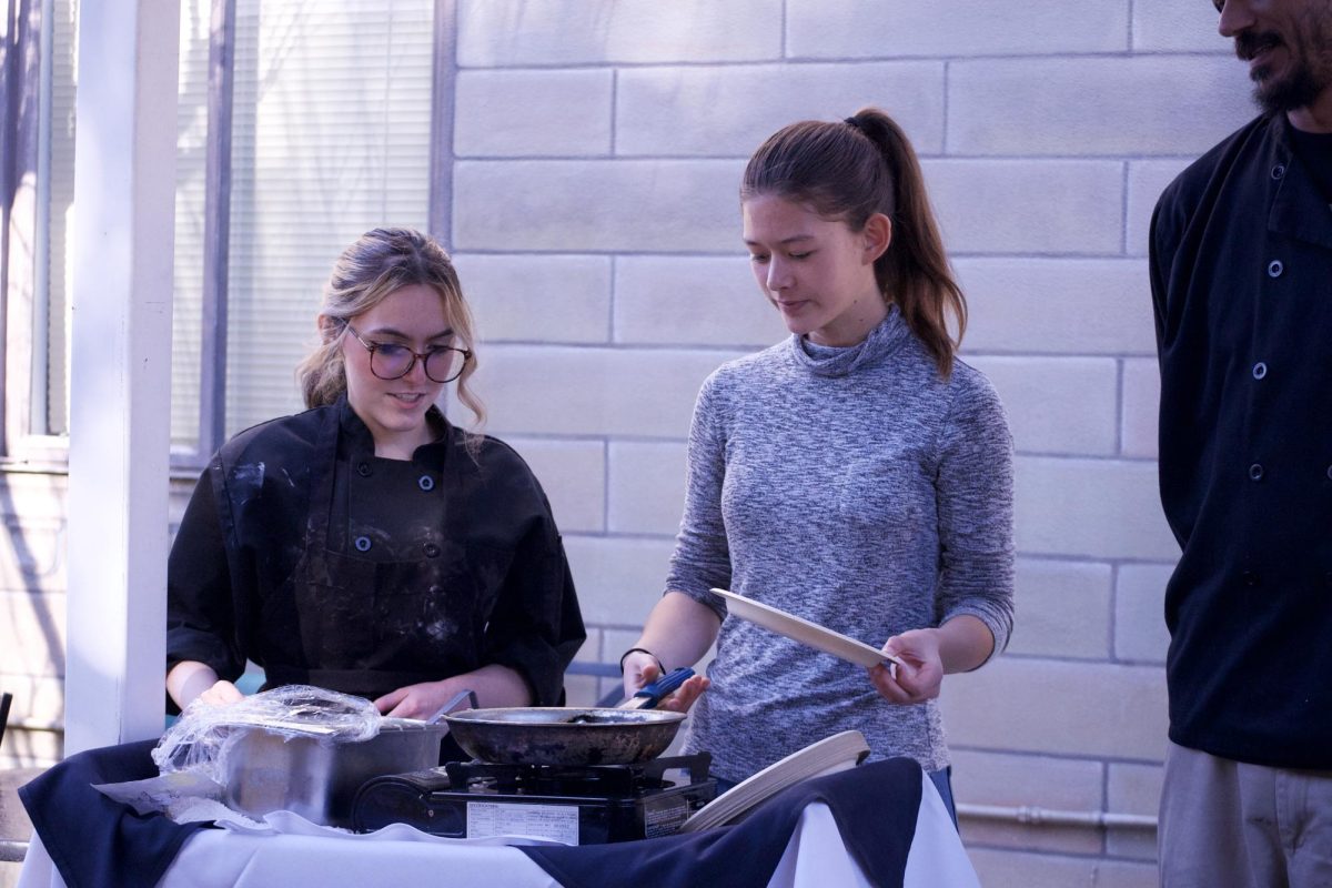 Sophomore Augusta Chen turns her pan to coat the bottom with the crêpe batter. To make sure that the crêpe was evenly cooked, students could either let the batter spread in the pan or manually turn it to brown the edges.