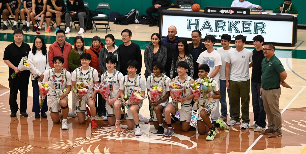 Seniors gather at half court for a photo with their family and friends. Alves and the rest of the team presented them with gifts.