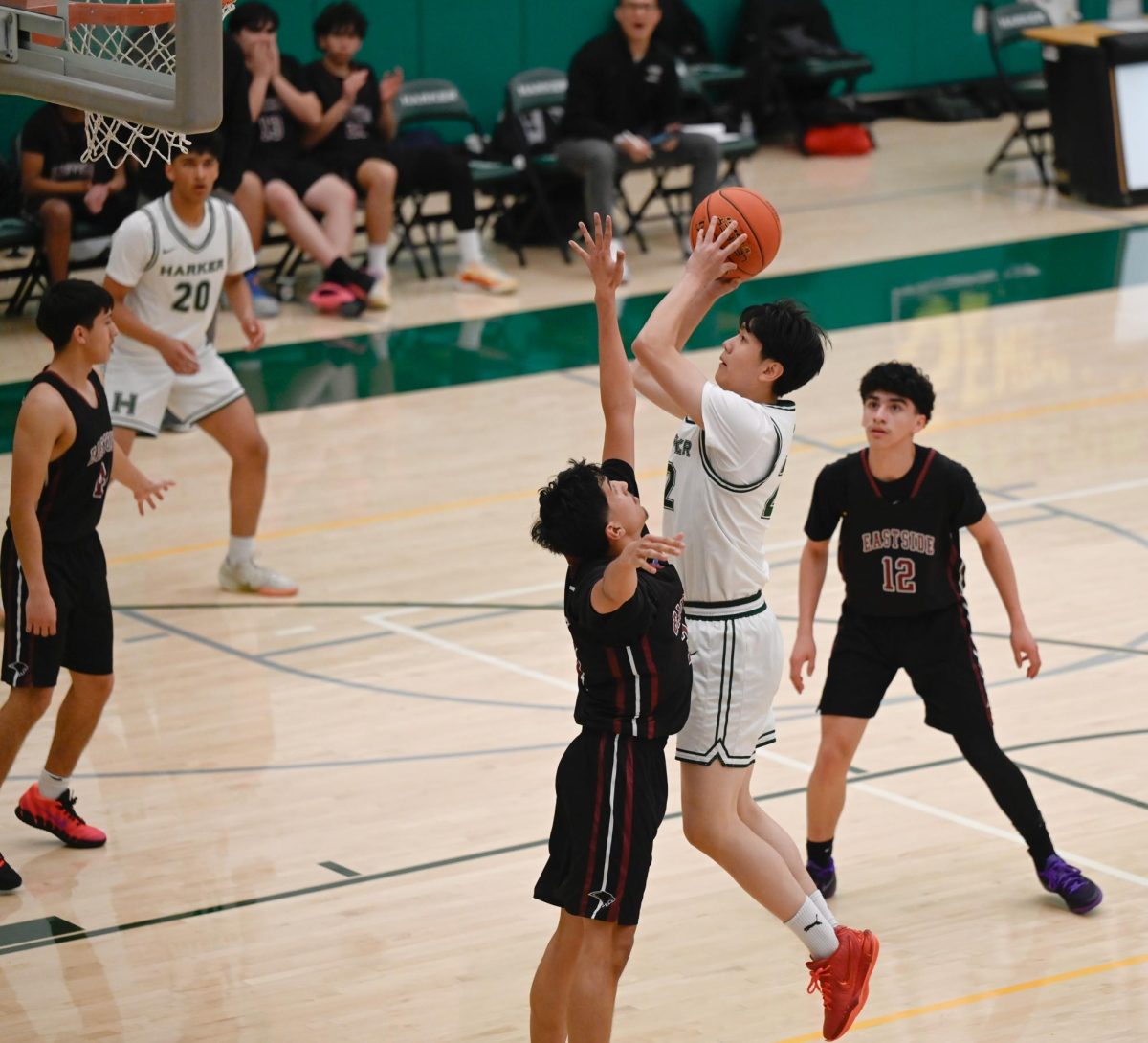 Center Oliver Chen (12) rises to loft a shot over his defender. Oliver scored the majority of the Eagles' points in the first quarter.