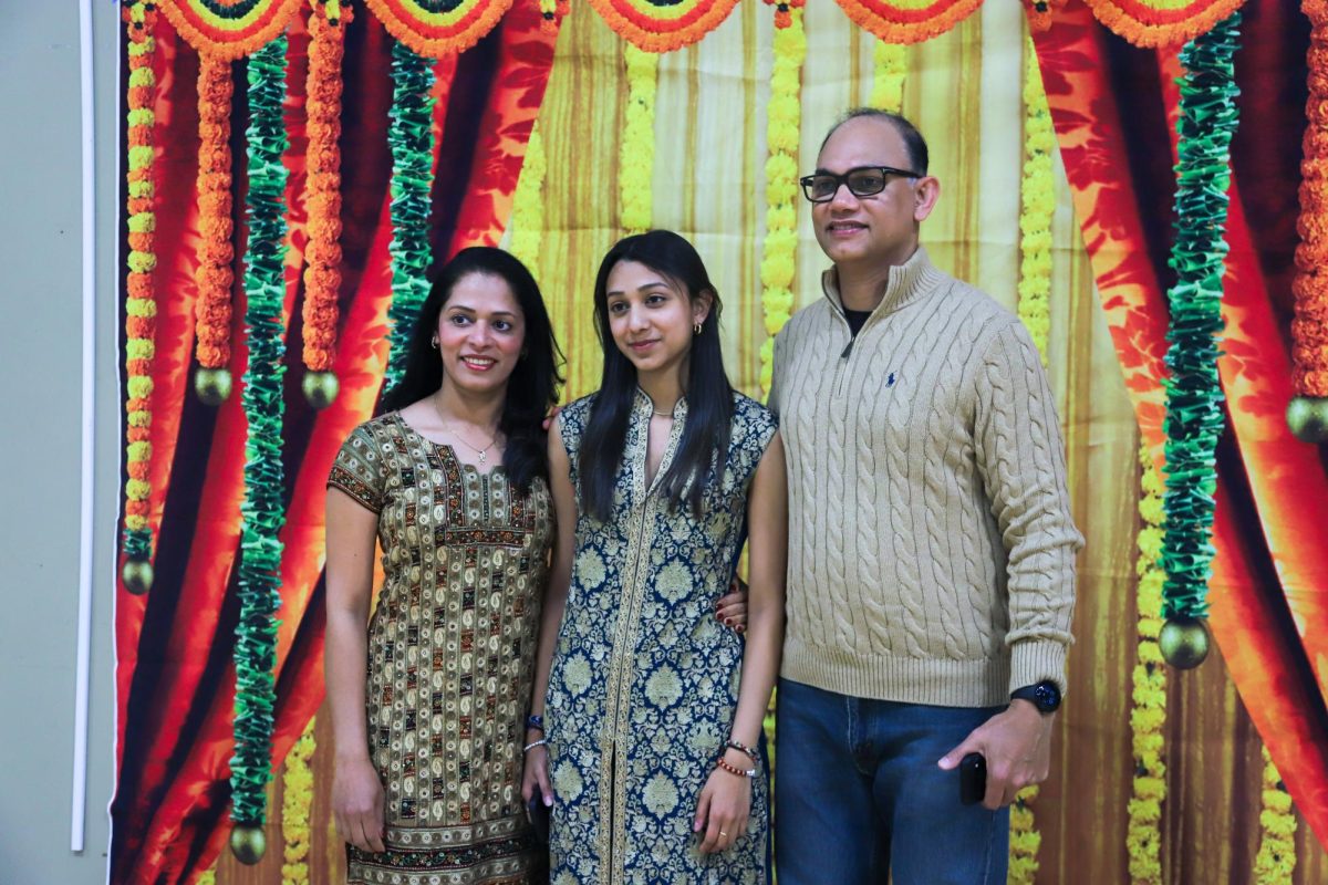 Senior Angelina Antony poses with her parents. Many attendees donned traditional Indian wear like kurtas.