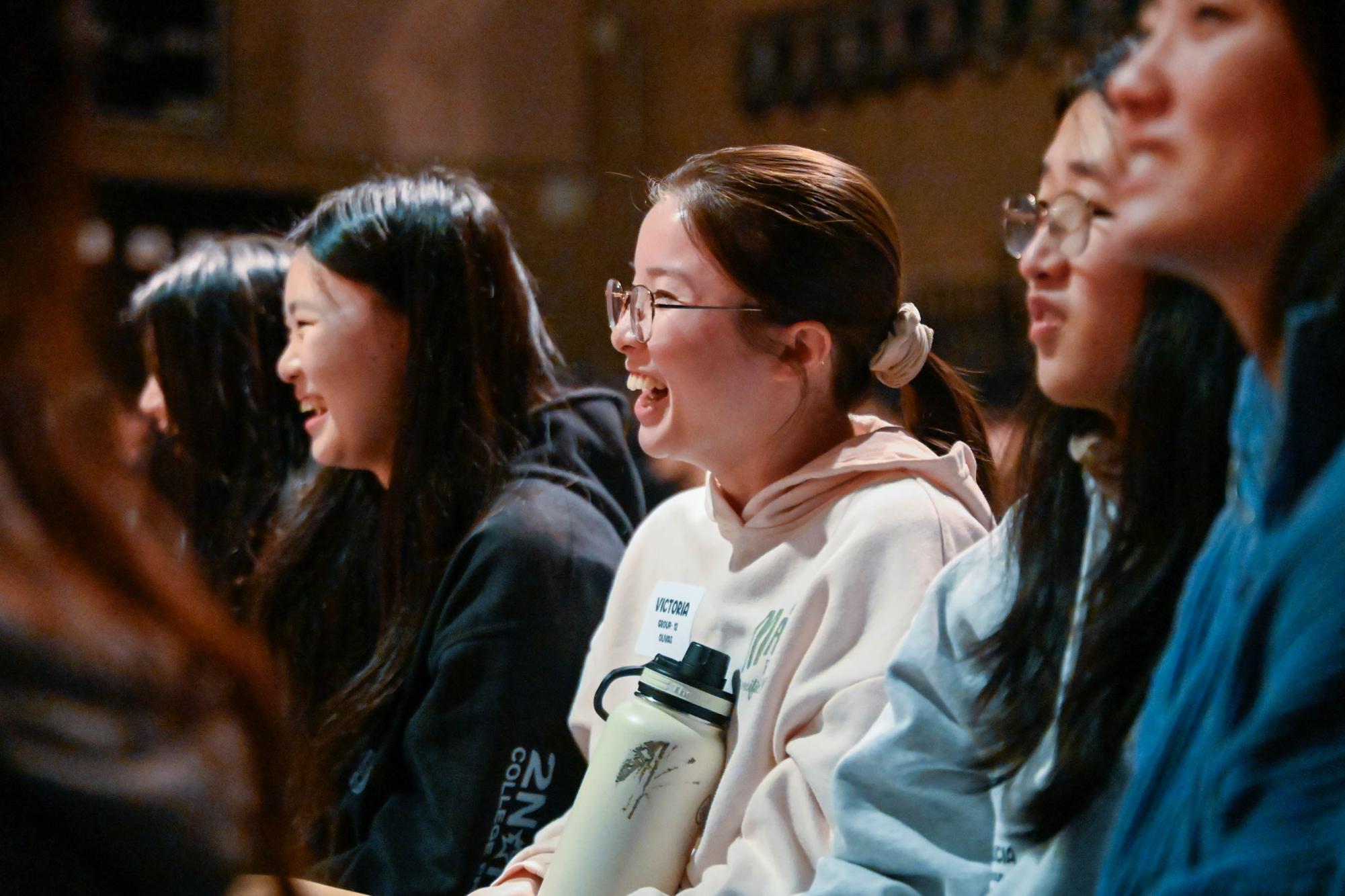 Senior Victoria Ma laughs as she watches the fifth grade play "Dig It!" at the lower school. For many seniors, the show held significance because they had performed the same musical seven years ago.