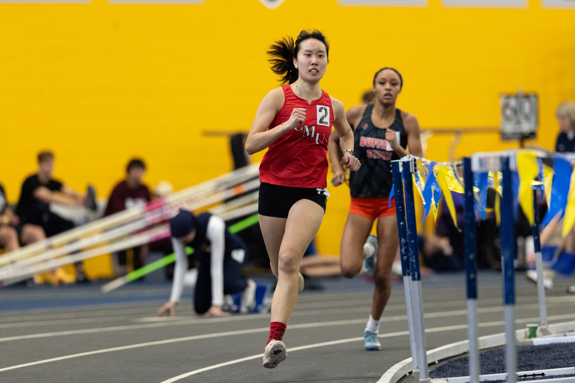 Alexa Lowe ('24) runs the curve during an indoor track race for Carnegie Mellon University. "What makes track sustainable and uplifting is the team around you. When everyone celebrates everyone's successes, that's when we're having the most fun," Lowe said. (Provided by Alexa Lowe)