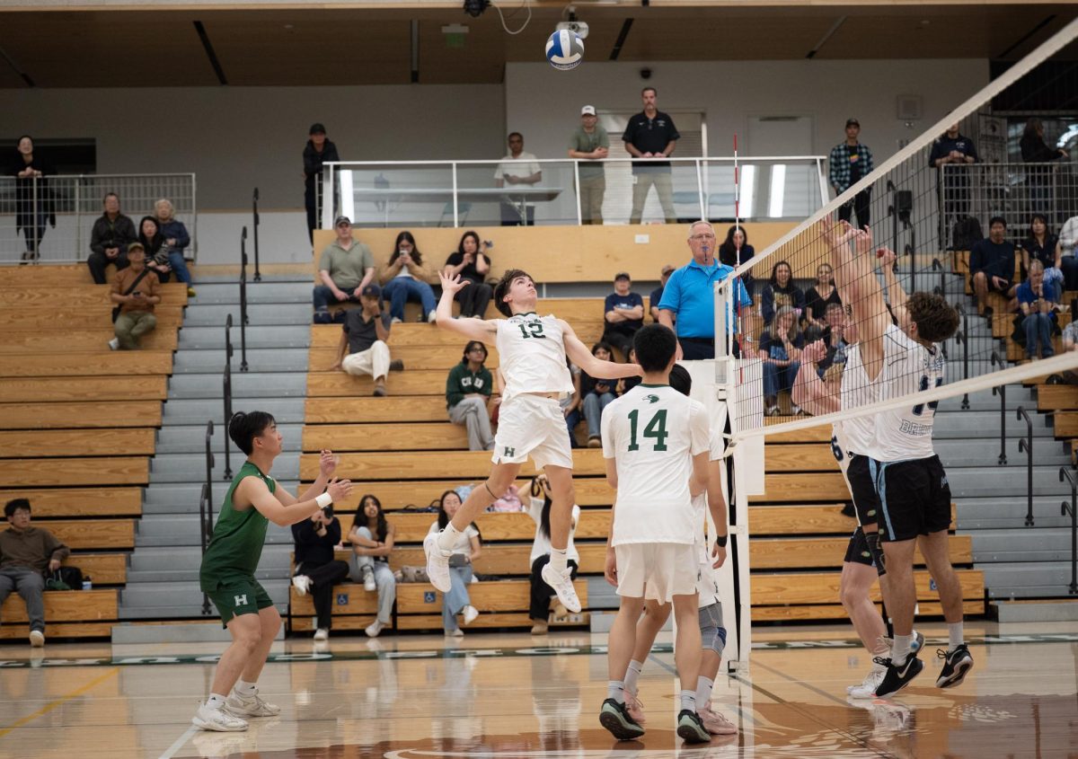 Co-captain and outside hitter Topaz Lee (12) extends to hit the ball. Topaz secured several well-timed cross-court kills during this game.