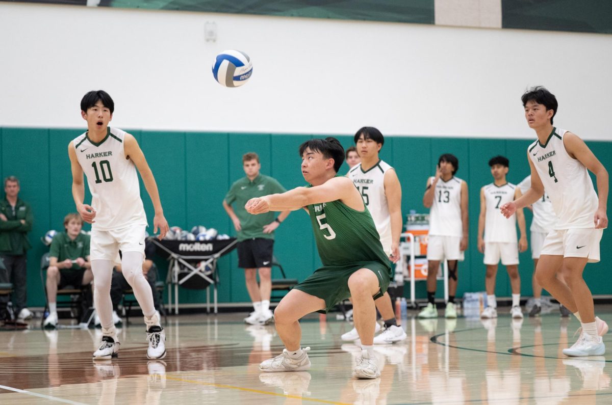 Co-captain and libero Luke Wu (12) returns a serve from Branham. Luke pulled off multiple close saves during the game.