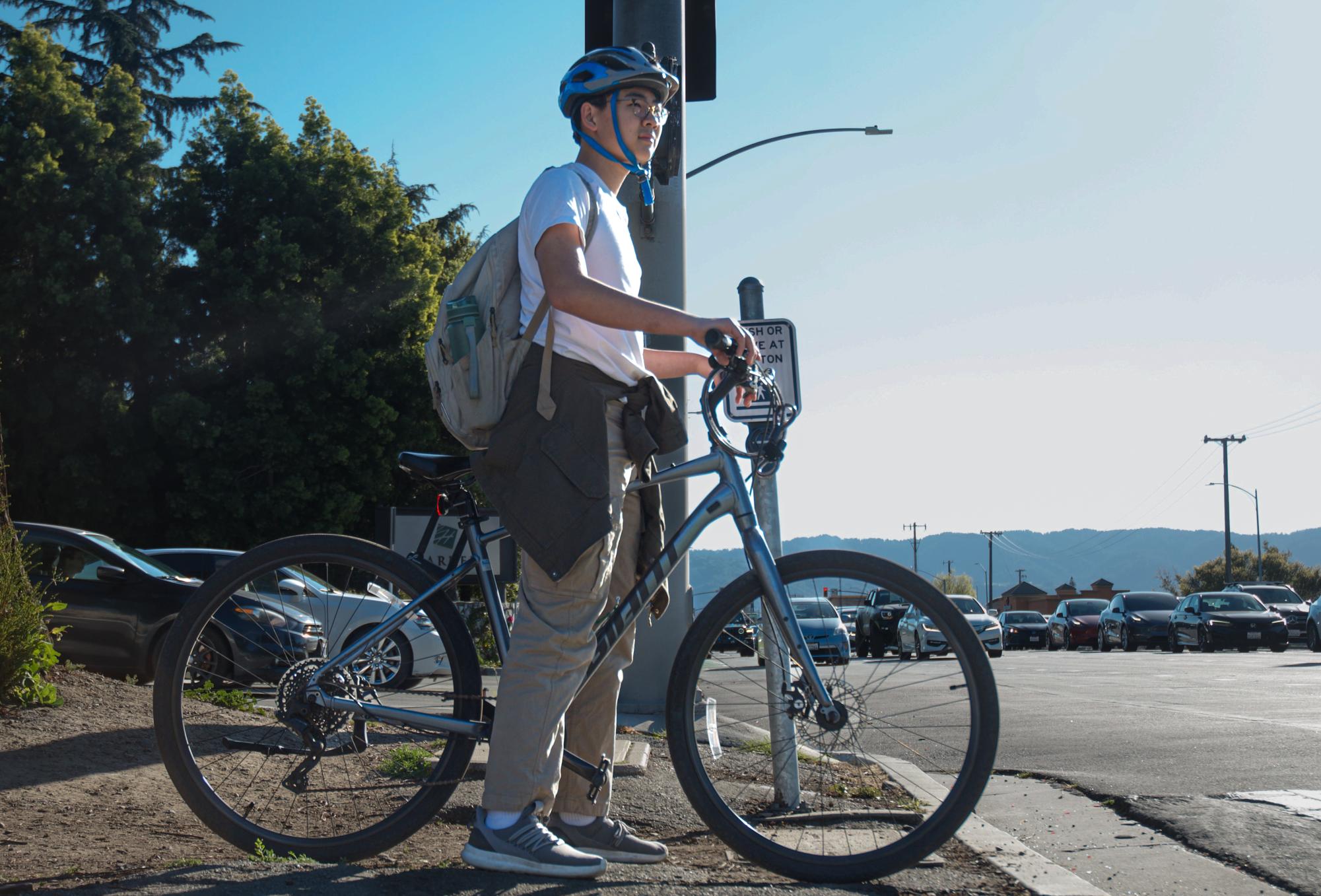 Bryan Ma (10) waits at the intersection across Saratoga Ave before crossing. Bryan has found a greater sense of independence and convenience through biking to and from school.