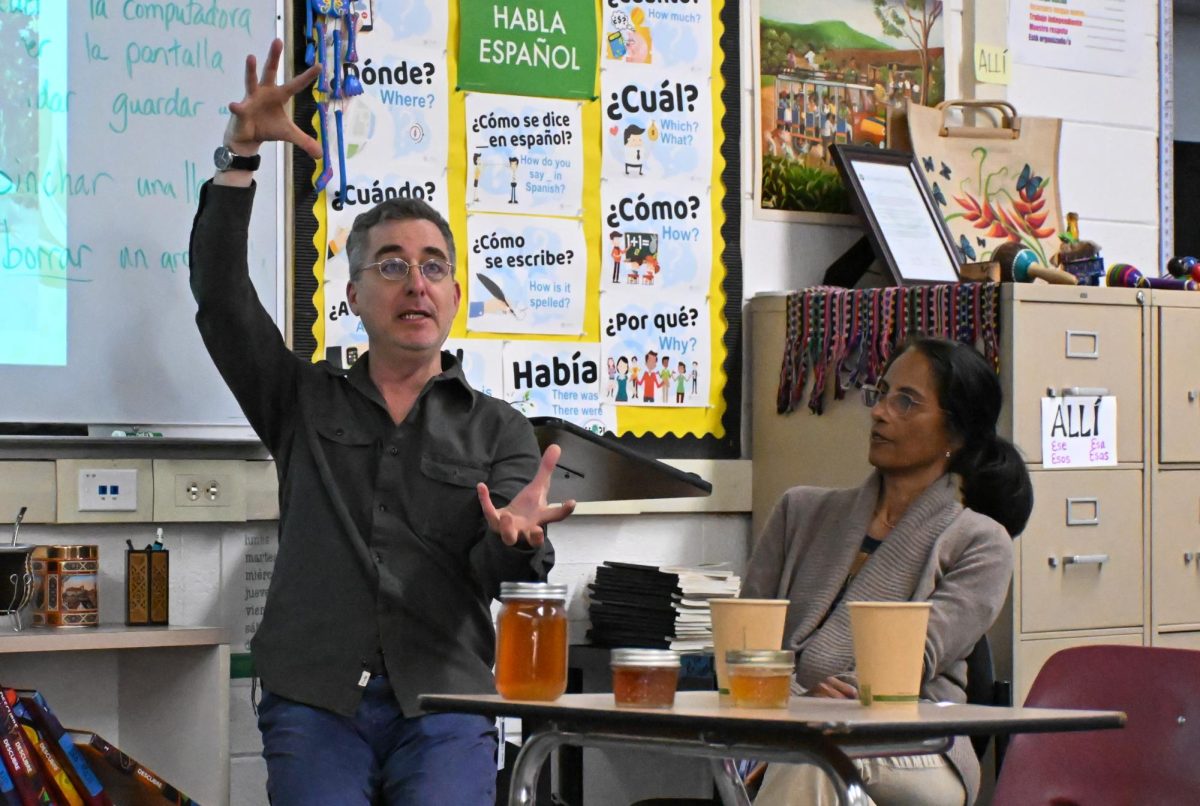 English teacher Nicholas Manjoine explains bee behavior during Green Team's beekeeping panel. Manjoine learned beekeeping from his grandmother and keeps hives in his yard.