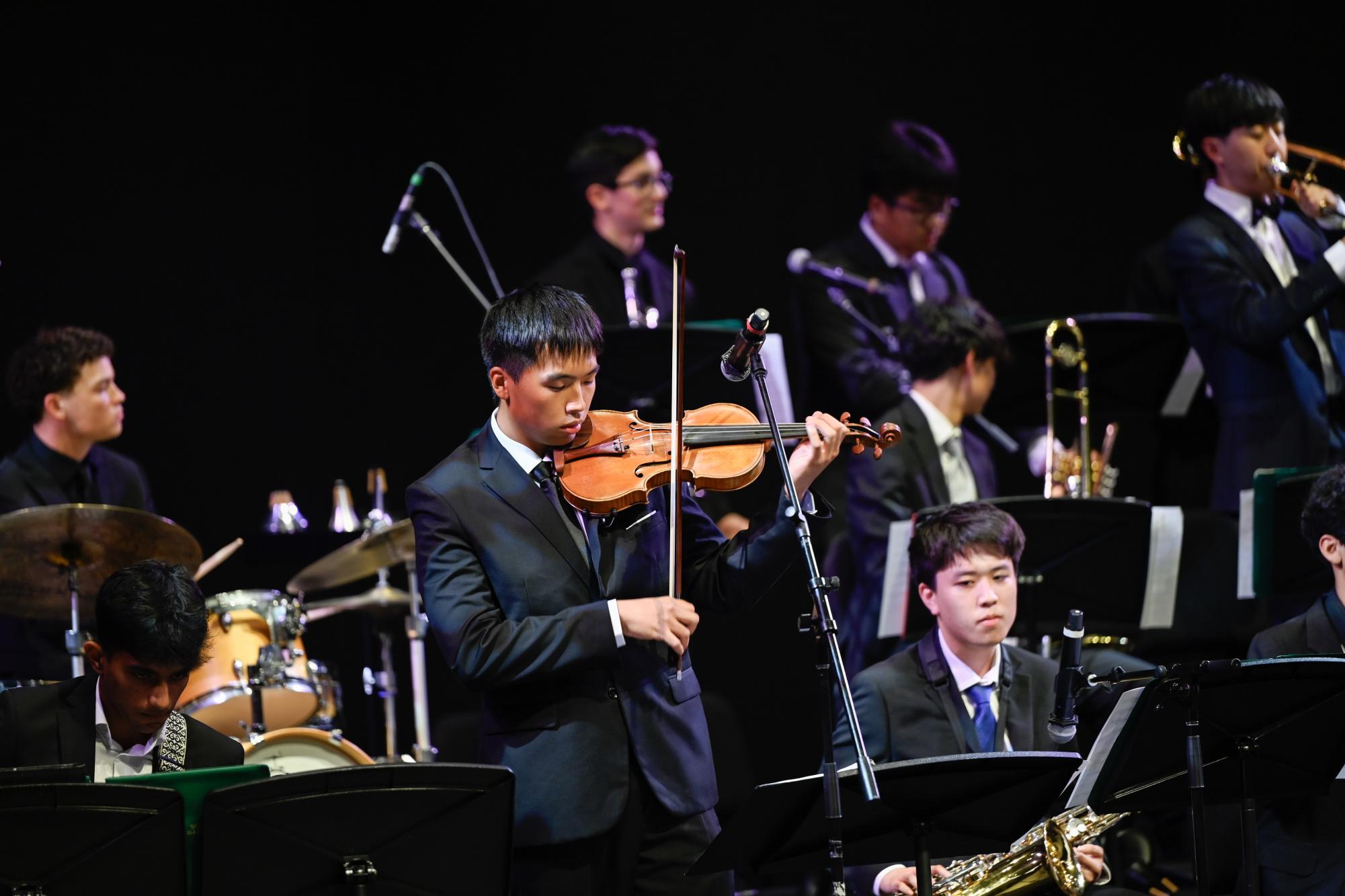 Senior George Yang solos during "Super Mario Ending Theme Song." Orchestra will be having their senior night at the spring instrumental concert on Thursday.