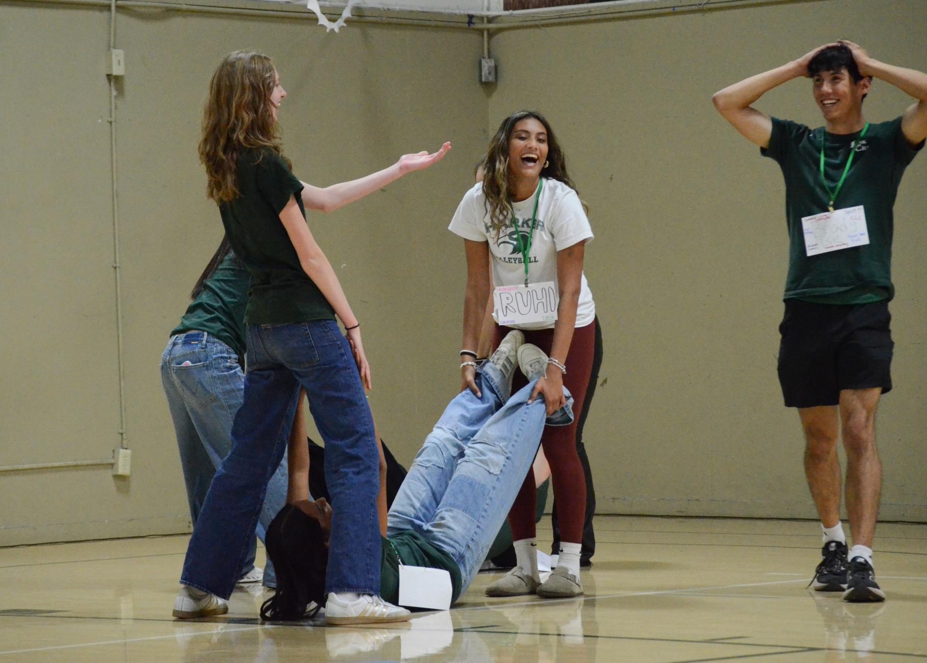 Link Crew members demonstrate the "Captain My Captain" game. On Welcome Night, they chatted with incoming frosh and introduced them to the high school.