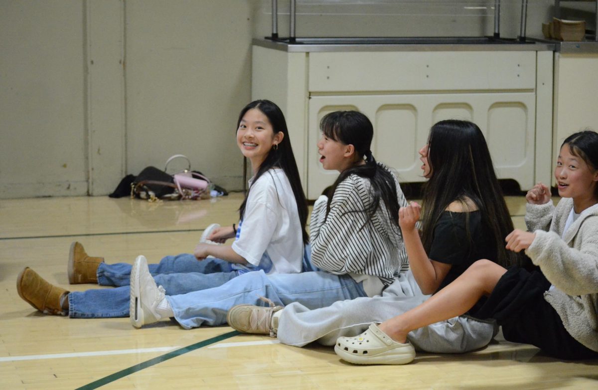 Eighth graders sit in a line during the "Captain My Captain" game, which encouraged teamwork through ship-themed instructions that required students to collaborate.