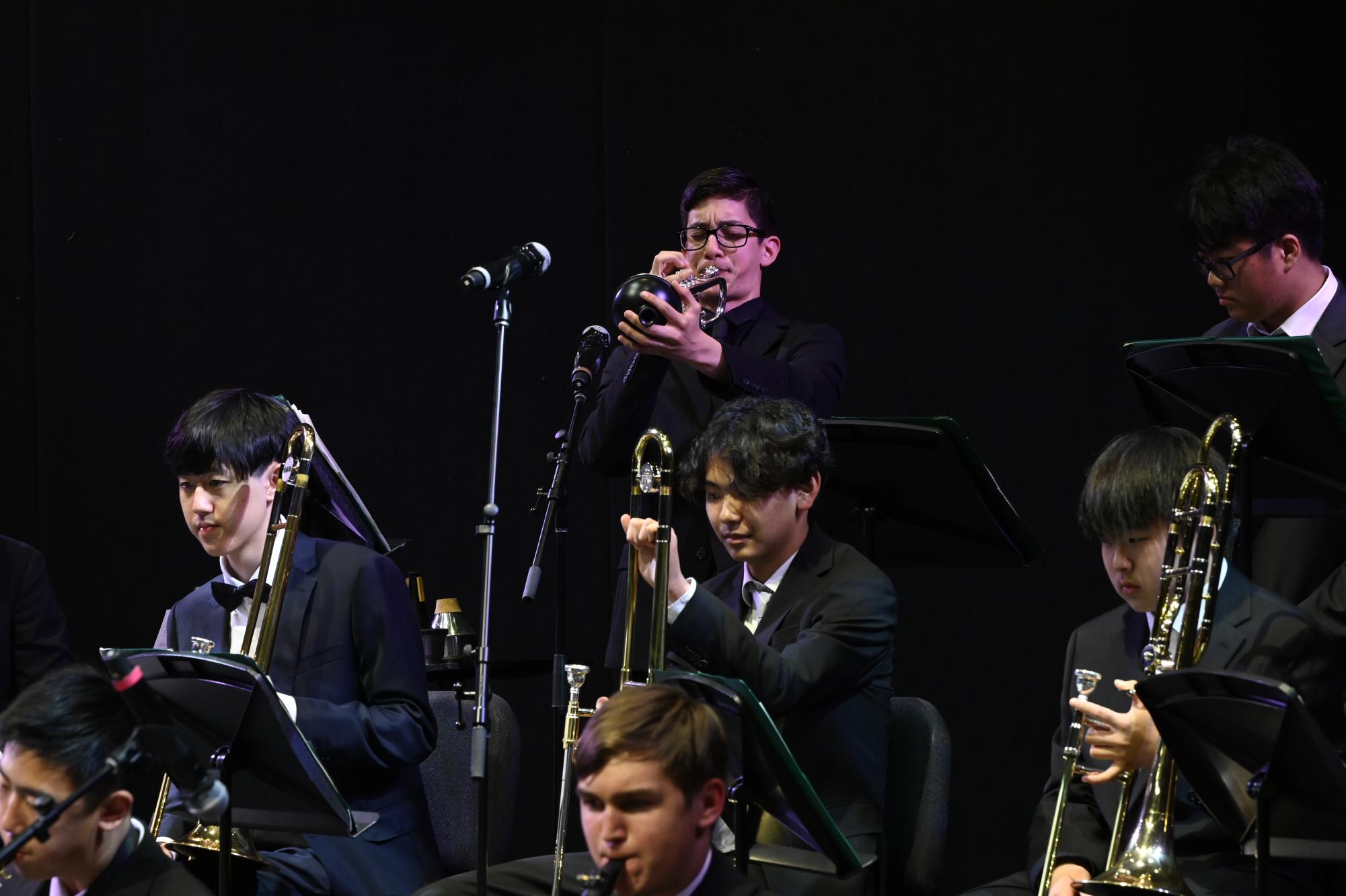 Frosh Nathaniel Steeg improvises a solo using a plunger mute. Every single member of Jazz Band had at least one solo moment to shine.