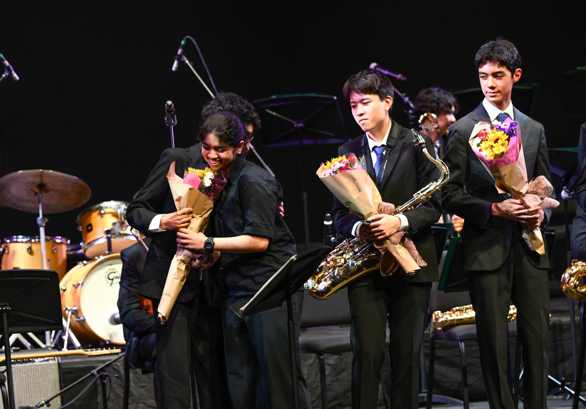 Junior pianist Anika Basu hugs senior alto saxophonist Rahul Sundaresan. Each of the seniors chose a jazz band member to deliver their flowers.
