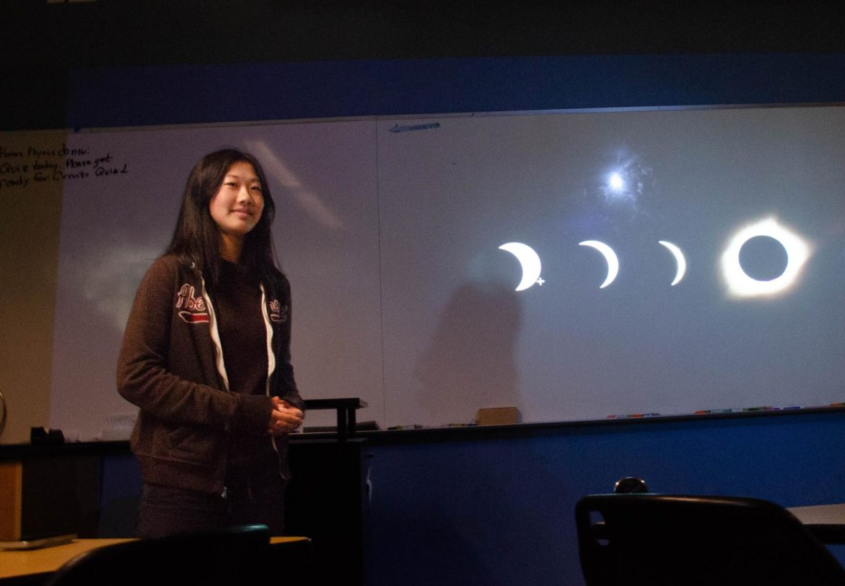 Astronomy club officer Isabelle Niu (11) listens to Astronomy club advisor Dr. Brada as he displays his own astrophotography images on the whiteboard. The meeting concluded as Dr. Brada showcased images of the eclipse, moon, and El Capitan rock formation that he had previously taken.