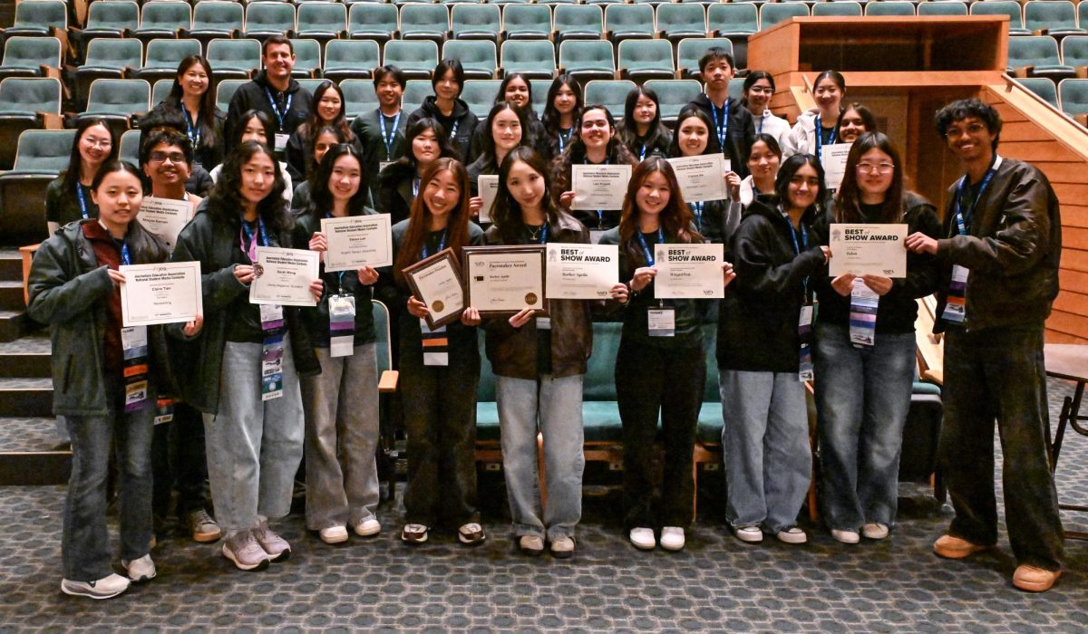 Harker Journalism staff poses with their awards in the convention center. Eight students won awards in the individual NSMC categories.