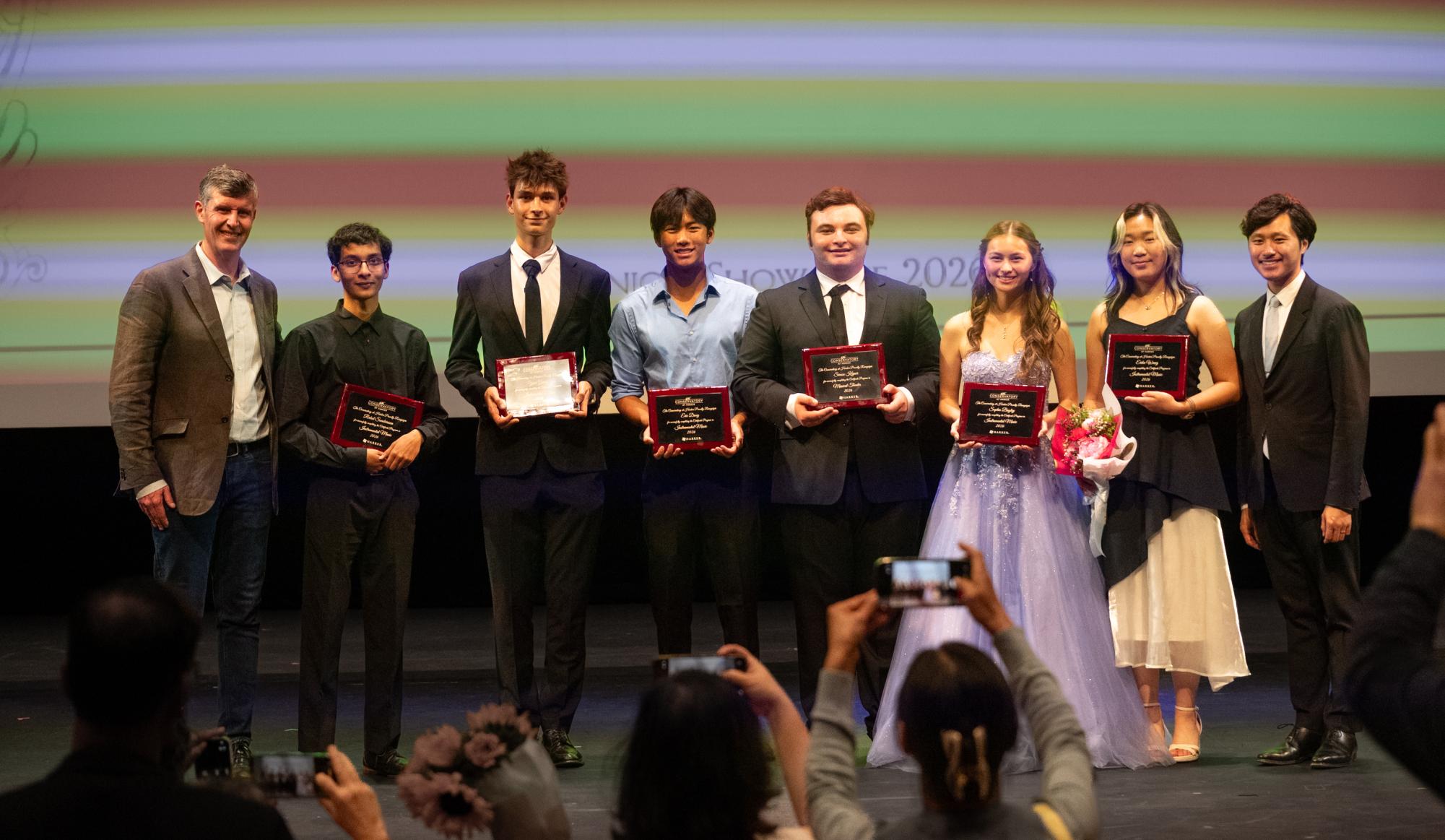 The instrumental music Certificate members pose for a photo with music teachers David Hart and Jaco Wong. In total, the night honored 24 performing arts seniors.