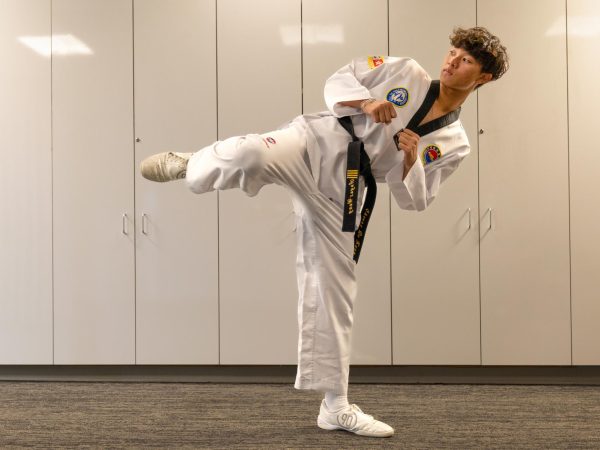 Sophomore Angus Wang chambers his leg, ready to unleash a side kick. “My style of form in taekwondo is really powerful,” Angus said. “It’s about striking and getting close, going for the hits rather than small points.”