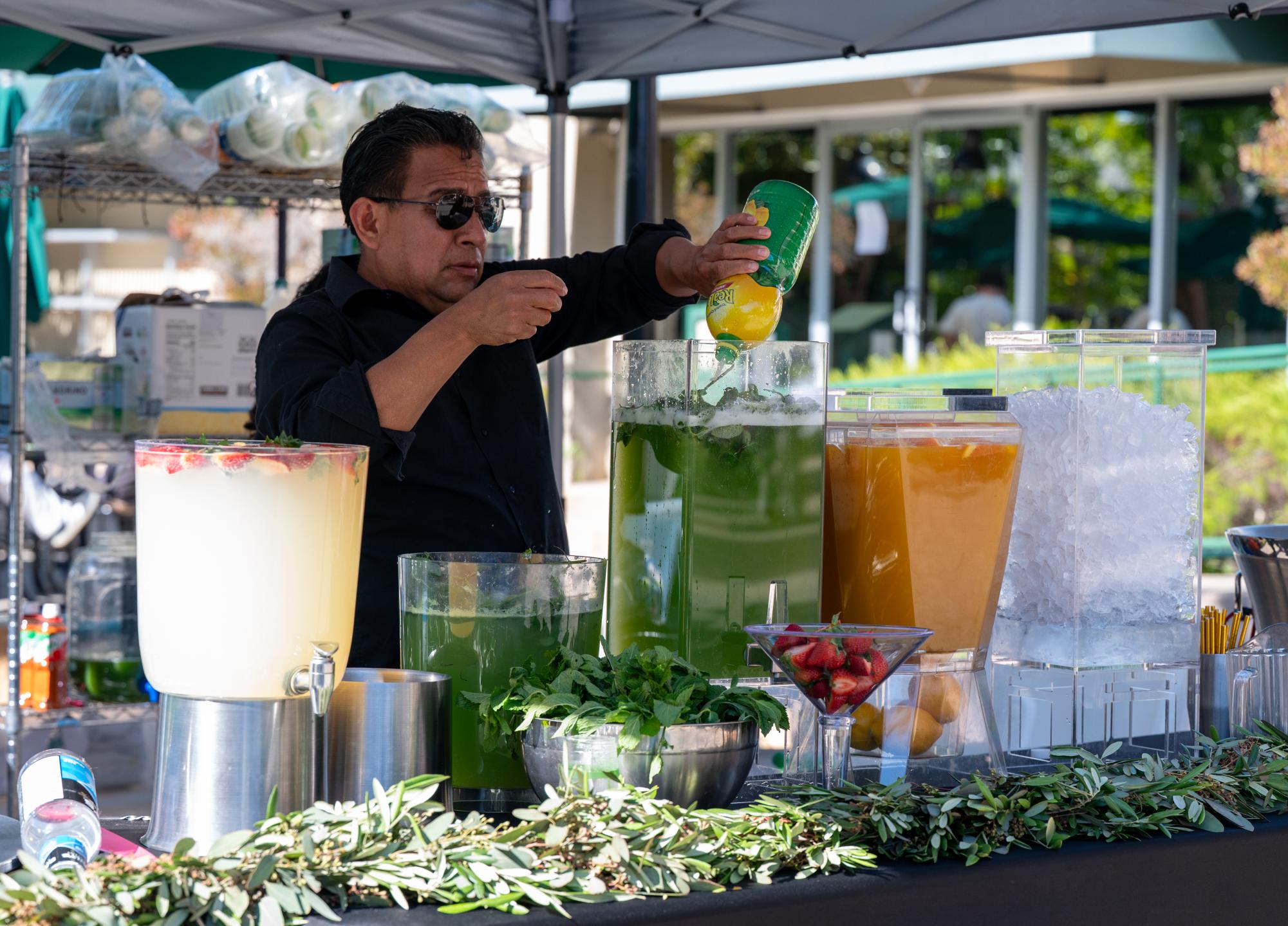 A kitchen staff prepares drinks before the Brick Ceremony. Drink options ranged from infused coconut water to mango nectar.