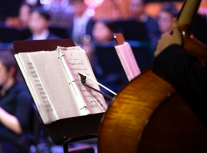 Junior double bassist Vova Shchegrov rests his bow on his sheet music for Mazzoli’s “Sinfonia (for Orbiting Spheres)." A sinfonia is also known as a hurdy gurdy, a medieval instrument.