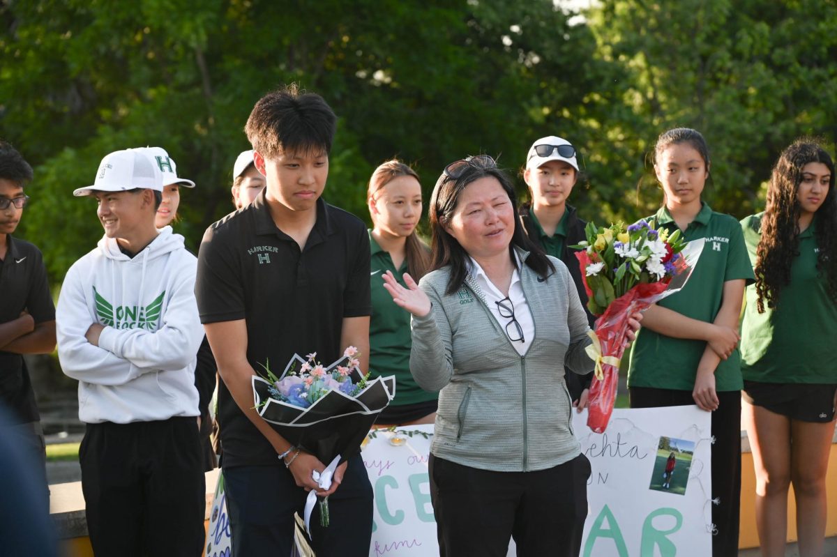 Head coach Ie-Chen Cheng congratulates senior Alan Gao for his time on the boys golf team. She delivered personalized speeches to each senior, starting with the boys team and ending with the girls.