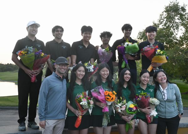 The golf coaches and seniors pose for a picture after the ceremony. Both teams went undefeated this year.
