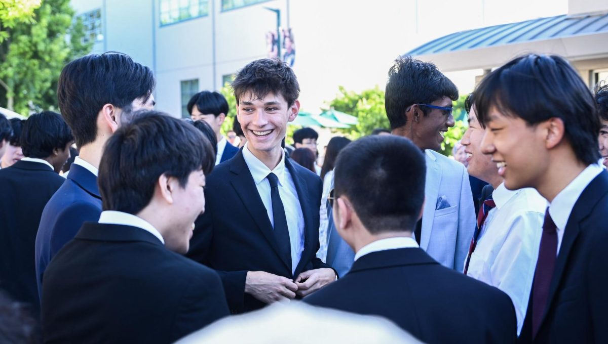 Senior Yash Greene laughs with his friends. Brick Ceremony was only the start of graduation events, with Baccalaureate and the senior trip following.