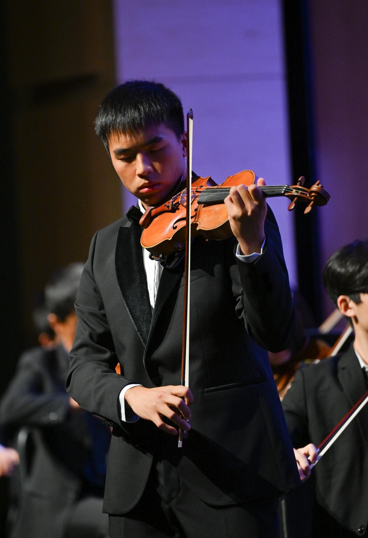 Senior concertmaster George Yang closes his eyes as he plays Pyotr Ilyich Tchaikovsky’s “Violin Concerto in D Major." George was one of three winners of the senior concerto competition.