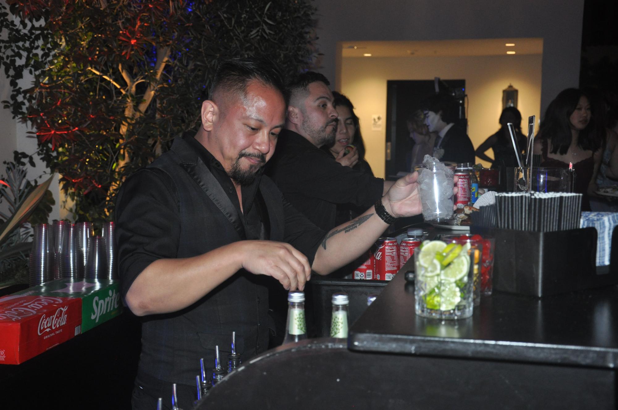 A member of the kitchen staff prepares a drink for the students to enjoy. The drink bar featured three mocktails: the Cranston, the Senior Sunset and the Mamma Mia Margarita. 