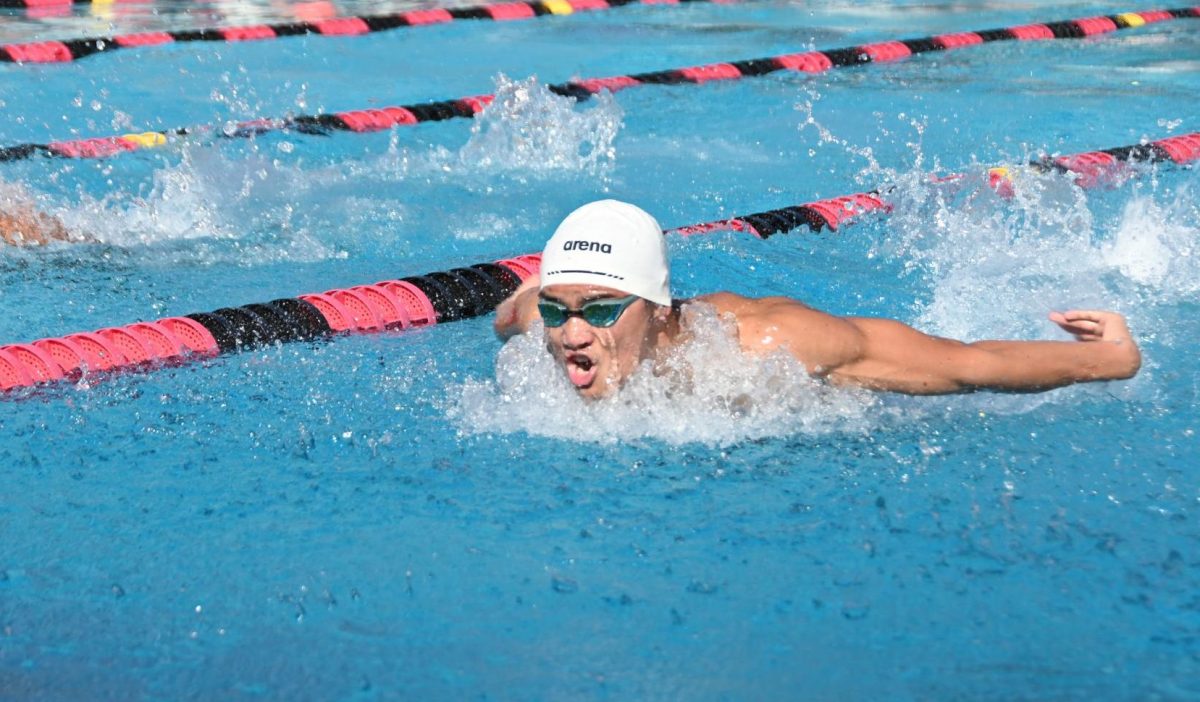 Junior Jaden Ruffy takes a breath while swimming butterfly. Jaden placed second in the preliminary trials of the 100-yard butterfly.