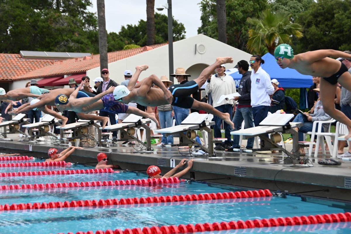 Andrew Woon (10) and Mark Han (9) leap off the blocks. Andrew and Mark placed fourth and sixth respectively in the finals of the 100-yard butterfly.