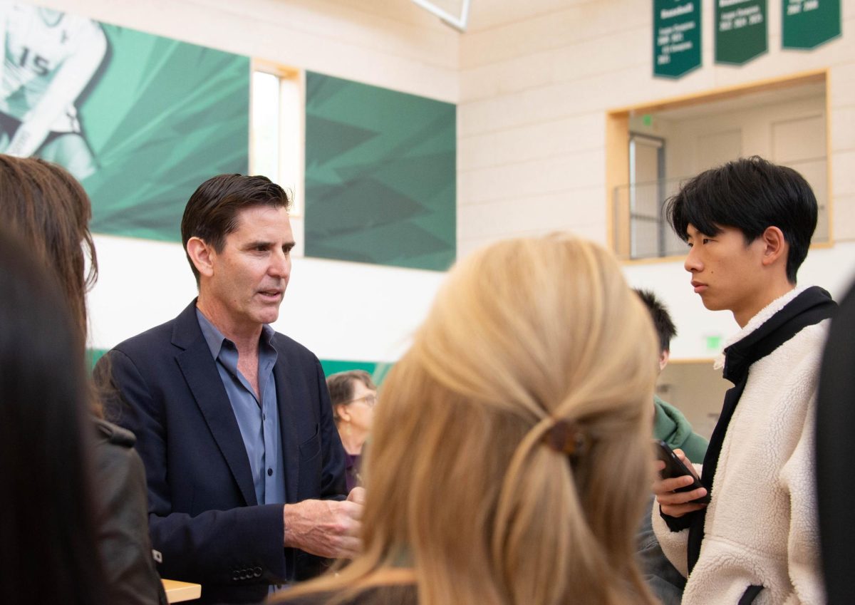 Following Stanford professor Mark Jacobson's speech, many students crowded around him to ask questions about how to solve the world's energy crisis. Jacobson centered his speech on how solar, wind and water energy could completely replace fossil fuels as an energy source.