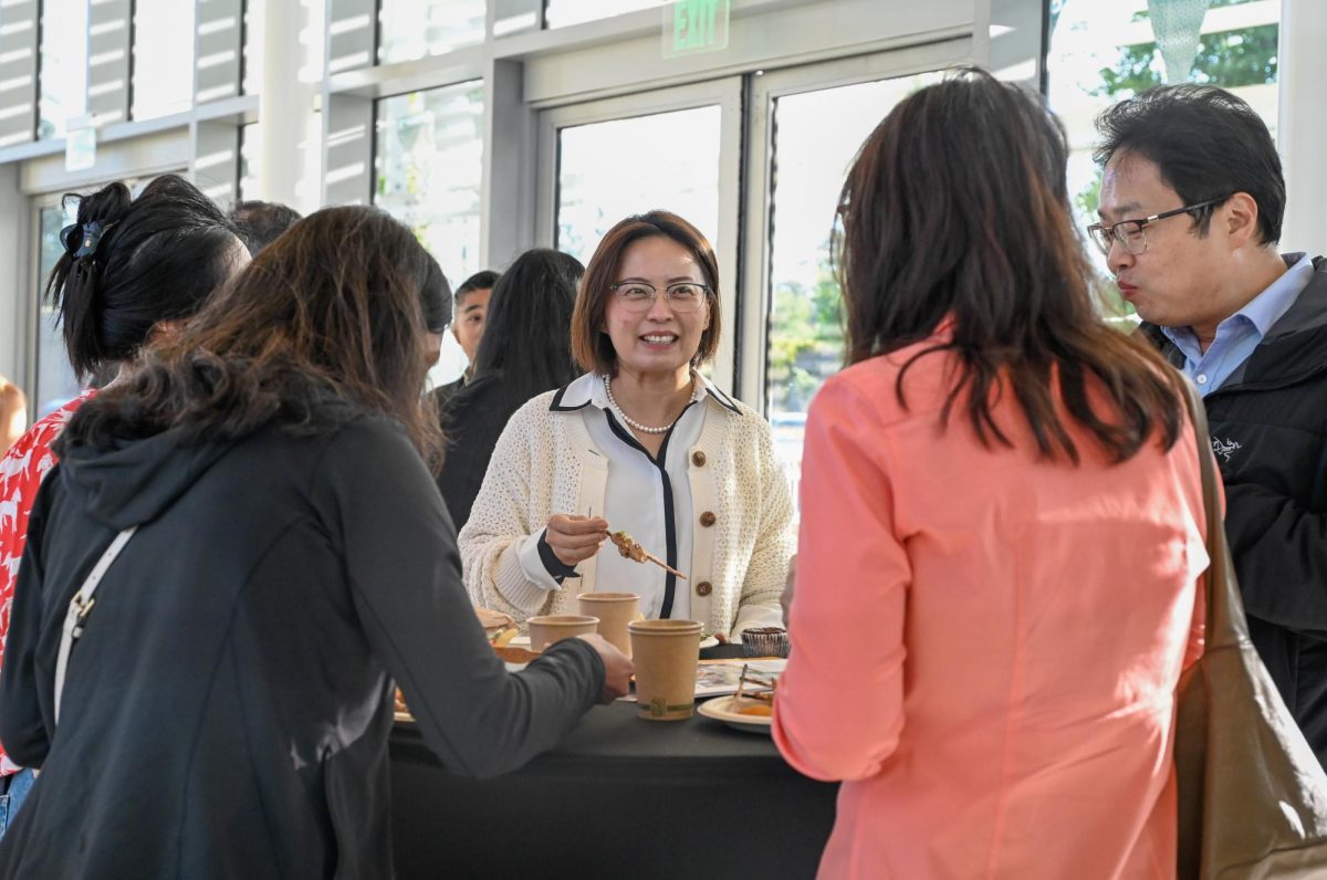 A parent laughs during dinner. Harker provided all attendees with dinner between the B&E presentations and senior and awards ceremony.