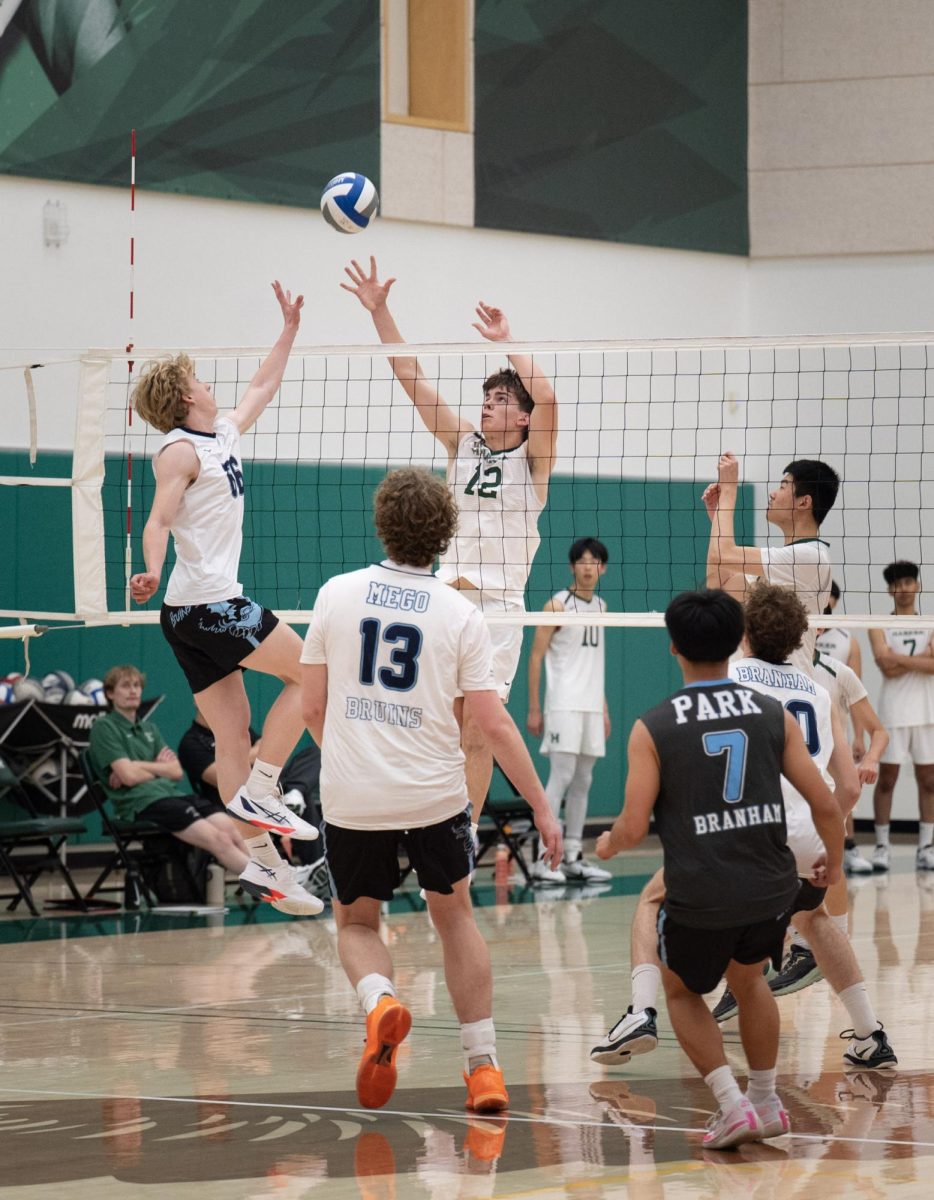 Co-captain and outside hitter Topaz Lee (‘26) tips the ball over Homestead’s blockers during the first set of their 4-0 win against Homestead High School on April 7. Topaz led the team to the CCS Open Quarterfinals, earning the league Most Valuable Player award at the end of the season.