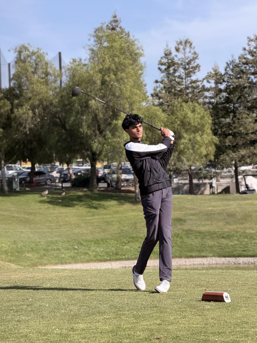 Vivek Yella ('26) swings his golf club in a friendly game at senior night at Los Lagos Golf Course on May 1. The team completed an undefeated 12-0 league season and secured the WBAL championship title.